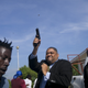 Ruling party senator Ralph Fethiere fires his gun in Port-au-Prince.